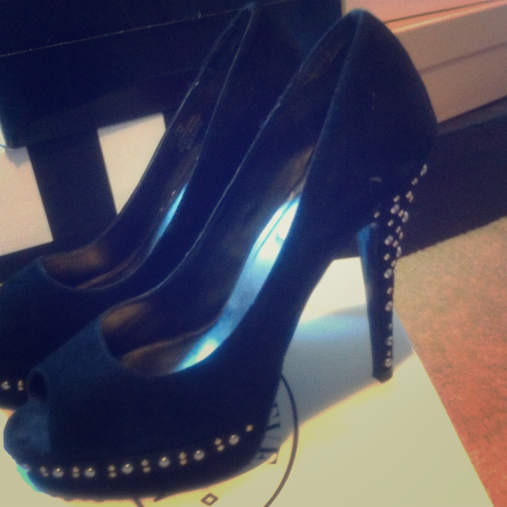 Sexy black suede peep toe pump with G/S studs.